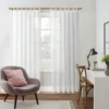 living room curtain rod Stylish living room with flowing curtains on a gold curtain rod, paired with a single seater, and a table —creating a chic, inviting ambiance