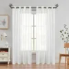 sheer curtains Elegant floor-length white sheer curtains gracefully hanging from sleek black curtain rods with bird finials, creating a modern and sophisticated window treatment