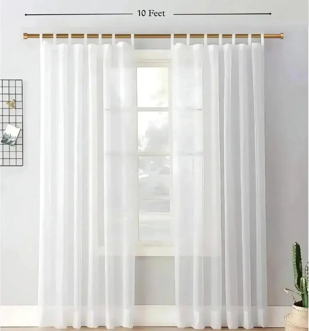 adjustable curtain rods 10 feet, Stylish living room with flowing curtains on a gold curtain rod, paired with a single seater, and a table —creating a chic, inviting ambiance
