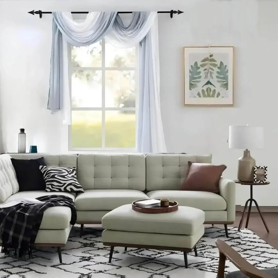 Stylish modern living room with valance curtains hanging from sleek black curtain rods, complemented by a cozy sofa set. Showcases functional elegance for contemporary homes