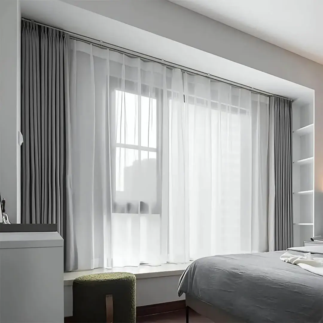 ceiling mounted curtain track, elegant sheer curtains hanging on a ceiling mount curtain track in a bedroom creating an inviting ambiance.