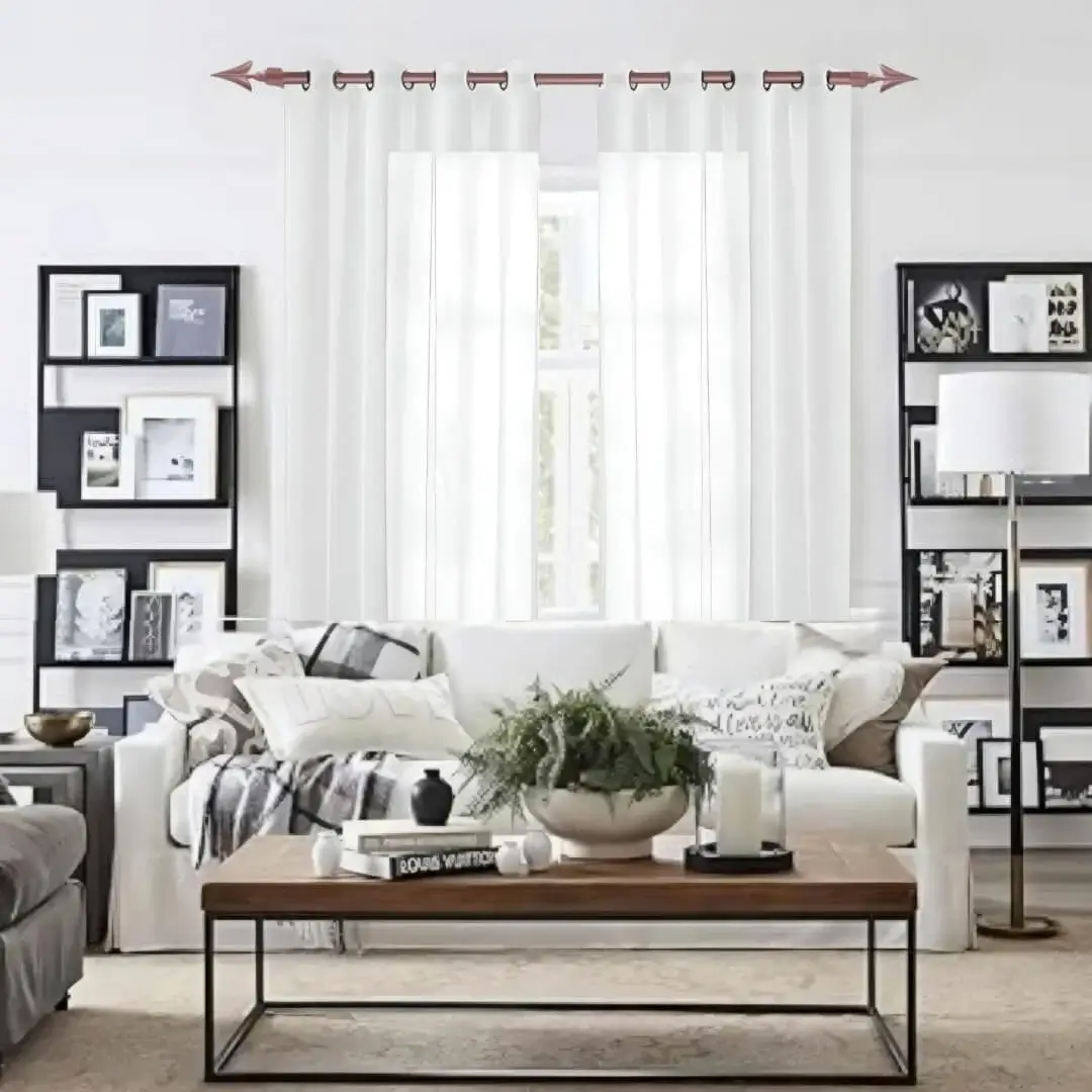 Stylish living room with flowing curtains on a rose gold curtain rod, paired with a cozy sofa set, vibrant cushions, and wall paintings—creating a chic, inviting ambiance