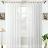 lace curtains Elegant sheer curtain gracefully hanging from a sleek antique curtain rod with leaf finial installed on a small window, creating an airy and sophisticated look