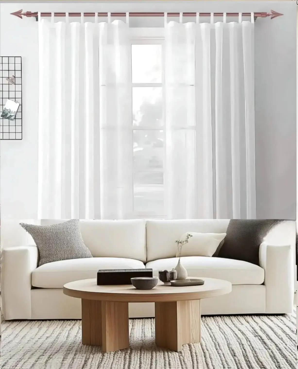 Stylish living room with flowing voile curtains on a rose gold curtain rod, paired with a cozy sofa set, vibrant cushions, and wall paintings—creating a chic, inviting ambiance