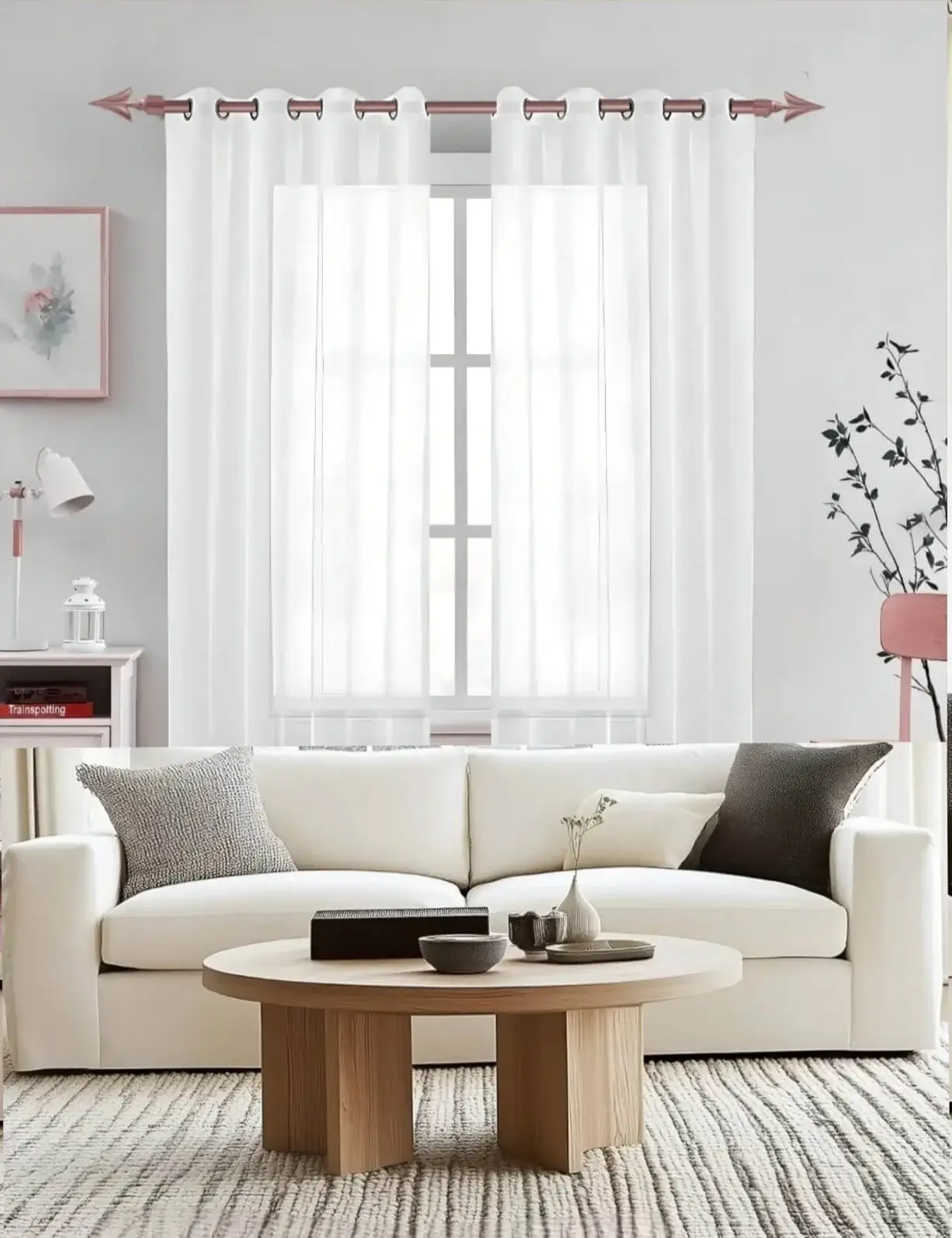 Stylish living room with flowing net curtains on a rose gold curtain rod, paired with a cozy sofa set, nice cushions, and wall paintings—creating a chic, inviting ambiance