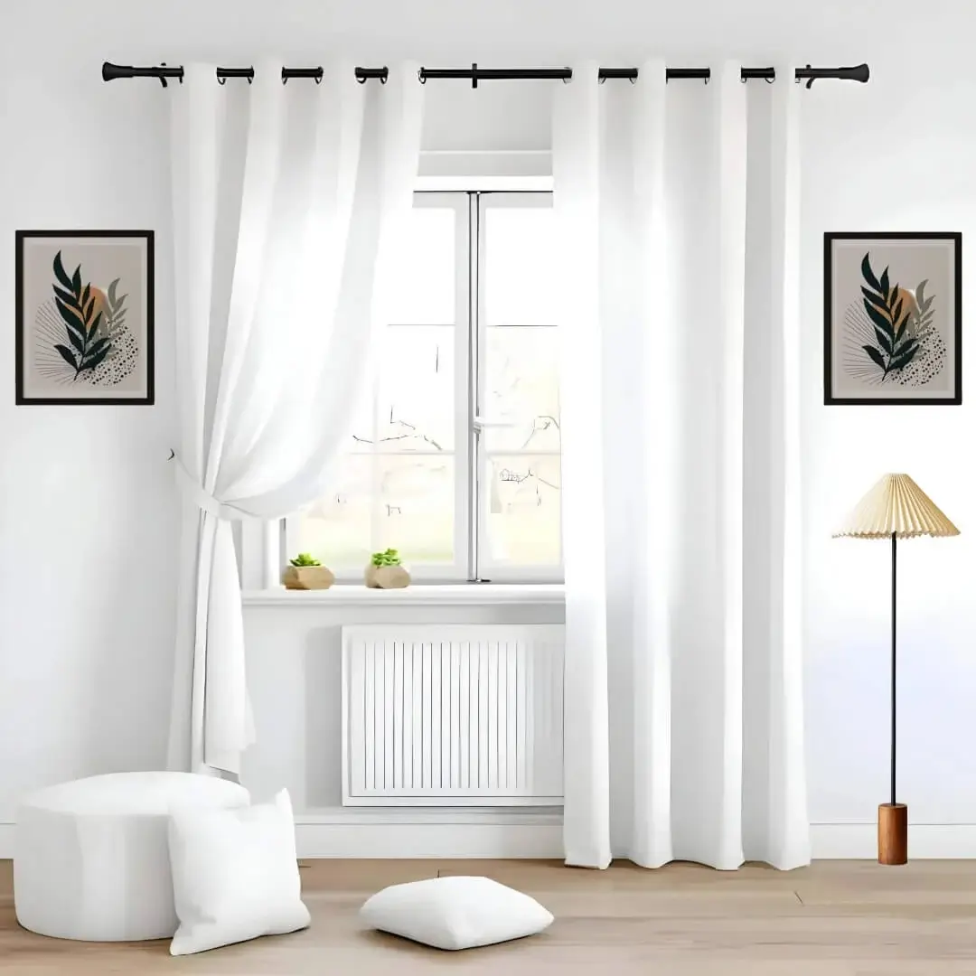 Elegant floor length white sheer curtain gracefully hanging from a sleek black curtain rod installed on a small window, creating an airy and sophisticated look