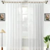 sheer curtain Elegant sheer curtain gracefully hanging from a sleek antique curtain rod with leaf finial installed on a small window, creating an airy and sophisticated look