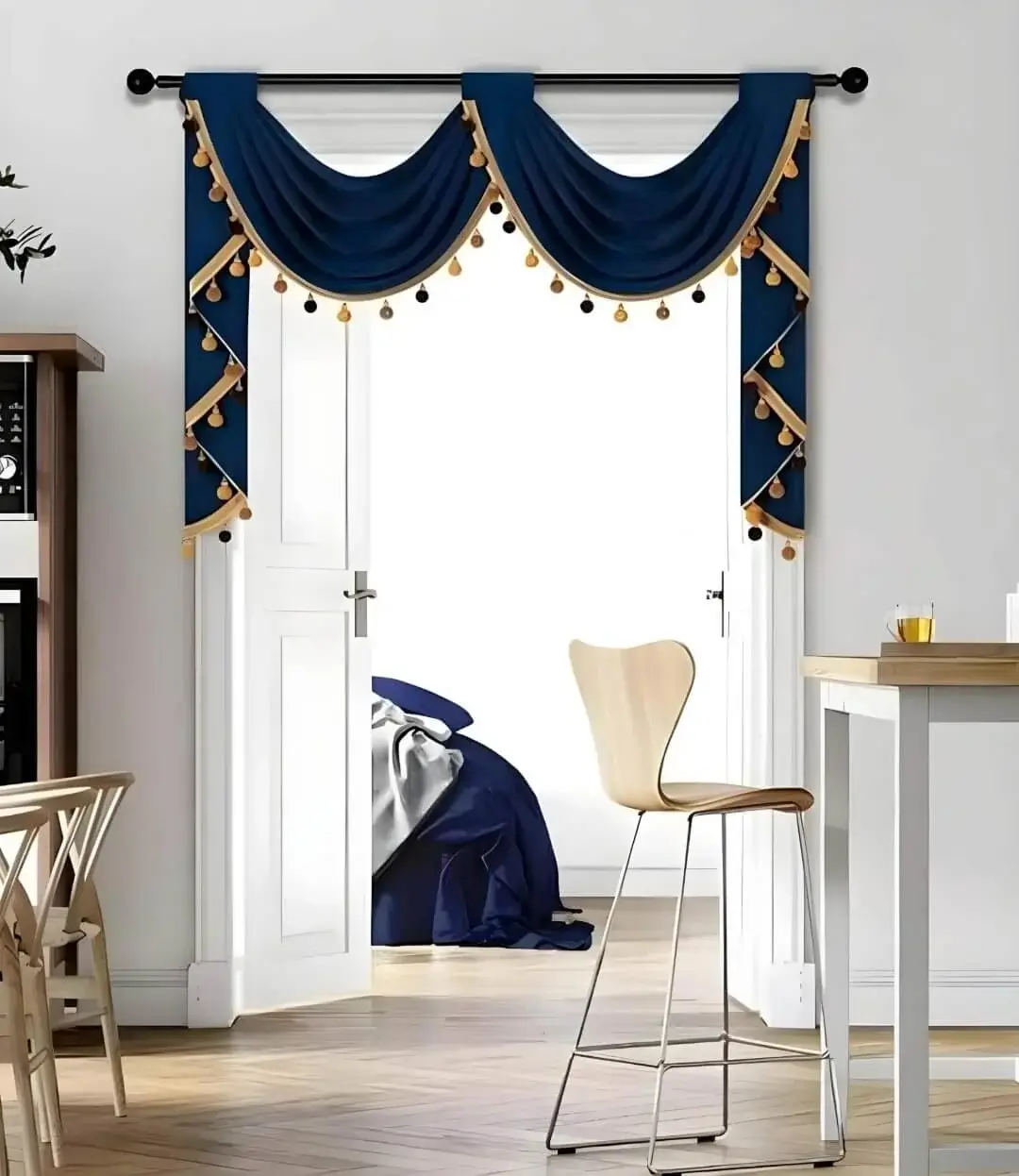 Elegant blue valance curtain gracefully hanging from a sleek black curtain rod installed on a small door, creating an airy and sophisticated look