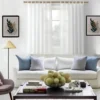 12 feet curtain rod for living room Stylish living room with flowing curtains on a 12 feet long adjustable golden curtain rod, paired with a cozy sofa set, vibrant cushions, and wall paintings—creating a chic, inviting ambiance.