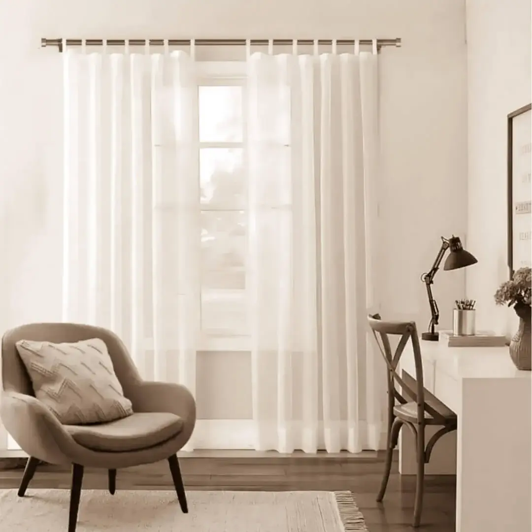 6 feet adjustable curtain rod for apartment - Stylish apartment living room with flowing sheer curtains on a brown colour 6 feet adjustable curtain rod, paired with a single seater, and a table —creating a chic, inviting ambiance.