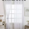 curtain rods for sheer curtains curtain rods for transparent curtains showcase: Elegant white sheer curtains hanging from a black metal curtain rod in a cozy living room, styled with a wooden side table, modern table lamp, and framed wall art for a chic home decor aesthetic